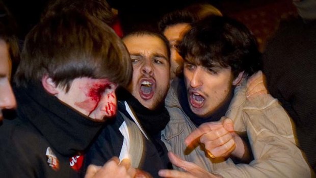Trouble on the streets ... a bloodied protester after being struck by police during a national strike in Madrid yesterday.