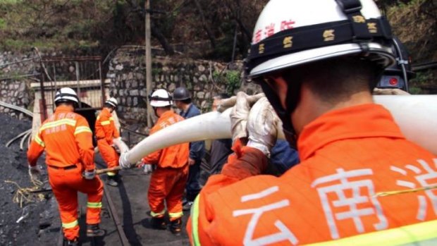 Rescuers bring a hose into the shaft to save the 22 miners trapped in a flooded coal mine in Qujing, southwestern China's Yunnan province.