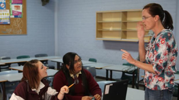 ‘‘It has made us learn more’’ ... says Rabia Muhammad, right, who with Lisa White, is trialling the new voice to text recognition system with teacher Sally Pape at Robert Townson High School.