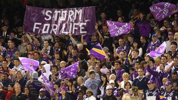 We're not going anywhere . . . Storm supporters make their feelings known at Etihad Stadium last night. A string turnout from their support base inspired Melbourne to a morale-boosting win.
