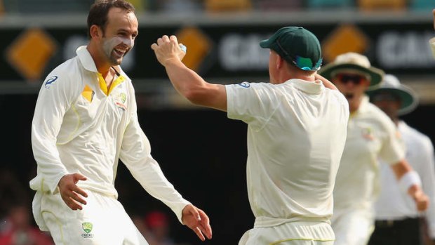 Nathan Lyon and David Warner celebrate after taking a wicket during day four of the First Ashes Test.