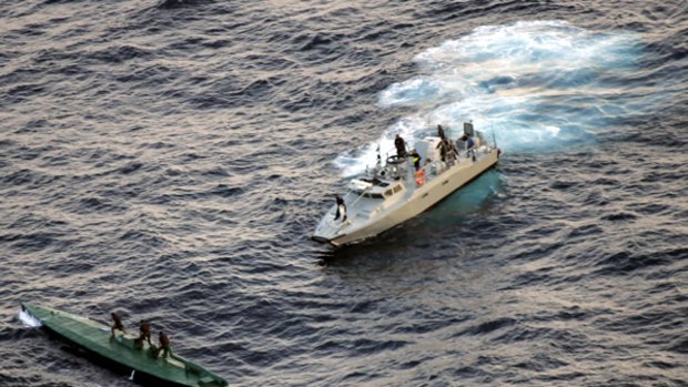 Mexican navy sailors ride on top of a seized drug smuggling submarine.