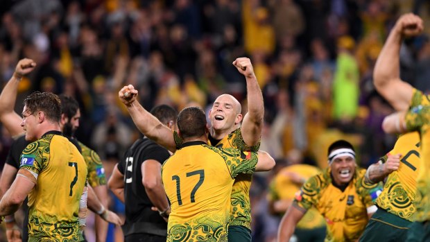 Finally: Stephen Moore embraces Tom Robertson after the Wallabies beat the All Blacks in Brisbane.