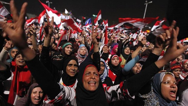 Protesters in Tahrir Square celebrate after the military coup.