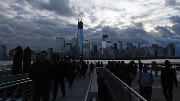 Commuters board a  ferry from Jersey City on the first day of opening since Hurricane Sandy.