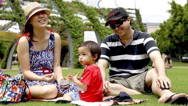 Mayuko and Jason Bock with 21-month-old son Liam at South Bank.