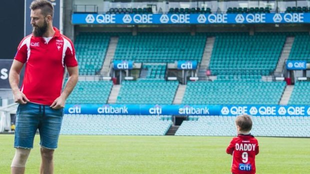 Nick Malceski plays with his son after a recovery session at the SCG on Saturday.