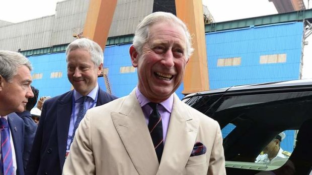 Britain's Prince Charles smiles as he interacts with officials during a visit to a shipyard to see India's first Indigenous Aircraft Carrier INS Vikrant in Kochi, India.