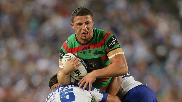 Tough nut: Sam Burgess hits the ball up with a fractured cheekbone in last year's NRL grand final.
