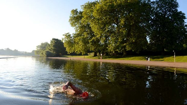 A swimmer in the Serpentine Lake at Hyde Park in London.