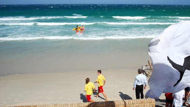 Grim task ... rescuers search off Fish Hoek beach after a shark killed a swimmer.