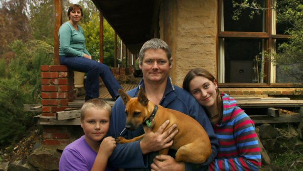 The Nicol family (above): mother Sally (rear) and father Andrew with Jess, Hayley and pet dog in front of their  Kinglake home, which survived Black Saturday's fires.