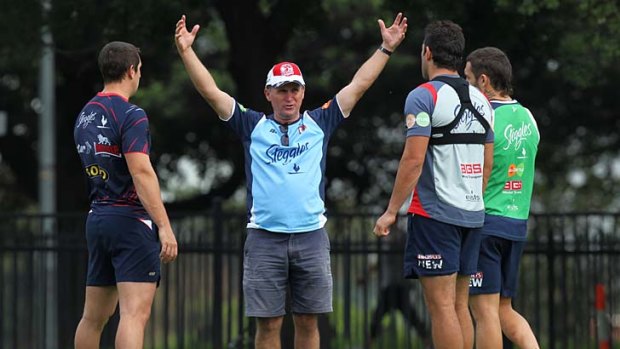 What next . . . Roosters coach Brian Smith chats with players at training. The latest problems facing his side have left many questioning the club's ability to repeat last year's success.