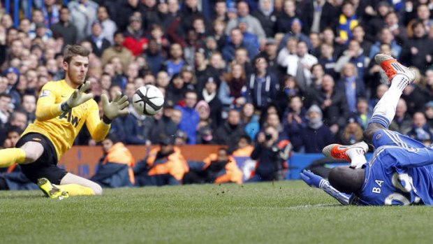 Nearly ... Chelsea's Demba Ba has a shot saved by Manchester United's Spanish Goalkeeper David De Gea during the FA Cup quarter final replay football match between Chelsea and Manchester United at Stamford Bridge stadium in London. Chelsea won 1-0.