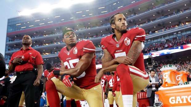 Taking a stand: San Francisco 49ers safety Eric Reid and former quarterback Colin Kaepernick kneel during the national anthem in protest of treatment of black people by police.