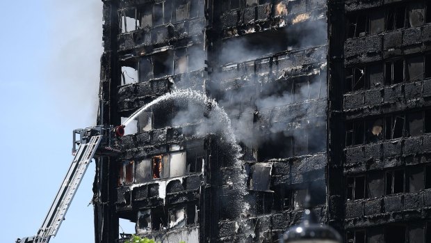 Fire fighters toil fruitlessly to quell the flames in the 24-storey Grenfell Tower in  West London.