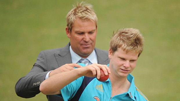 Mentor...Shane Warne gives Steven Smith some advice in the MCG nets yesterday.