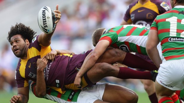 Don't look down ... Bronco Sam Thaiday tries to offload in a heavy tackle.