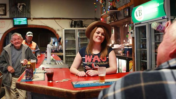 Wants to stay &#8230; English traveller Gemma Richardson working behind the bar at the Bucking Bull Hotel in Coonamble.