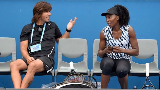 Influential: Player-turned-coach Mark Hlawaty chats with Venus Williams at a practice session at Melbourne Park on Saturday.