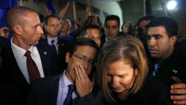 Isaac Herzog with Tzipi Livni, his co-leader of the centre-left Zionist Union party, campaigns outside a polling station in Modiin near Tel Aviv on Tuesday.
