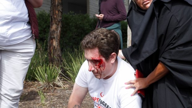 A bleeding right-wing activist outside Sunday's Halal festival. 