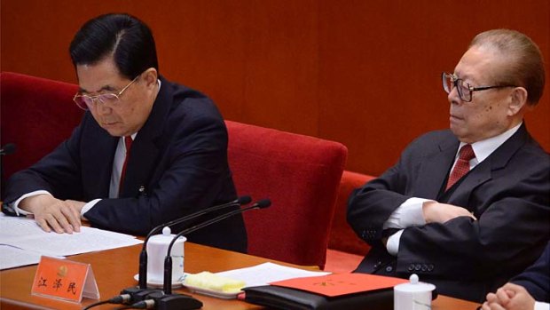 Just one look ... Jiang Zemin, right, looks at President Hu Jintao during the closing of the 18th Communist Party Congress.