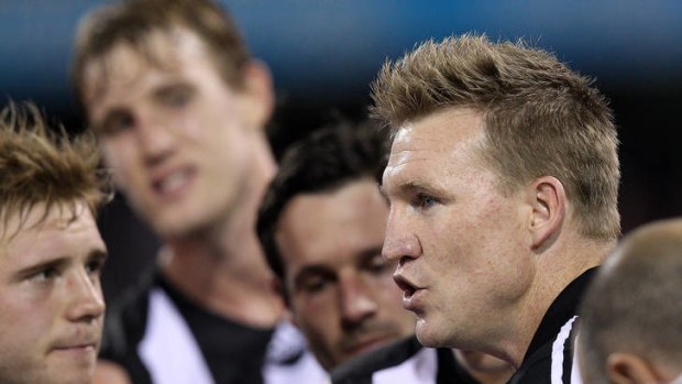 Getting his message across: Nathan Buckley has the attention of his players.