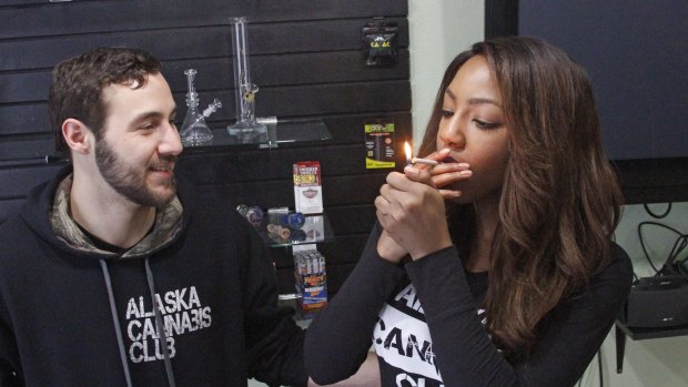 Peter Lomonaco, co-founder of the Alaska Cannabis Club, and CEO Charlo Greene share a joint at their medical marijuana dispensary in Anchorage, Alaska. 