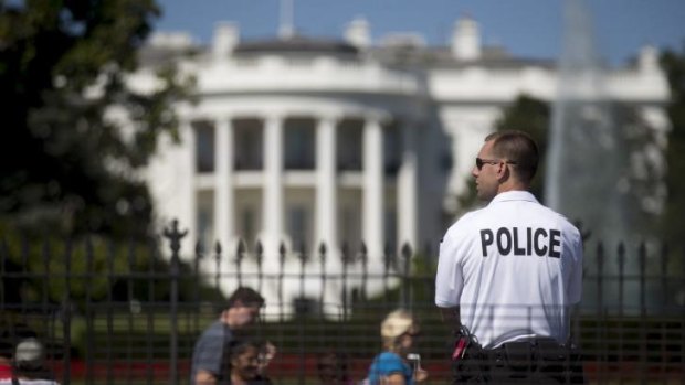 Not all guests welcome: a member of the Secret Service stands guard on the south side of the White House.
