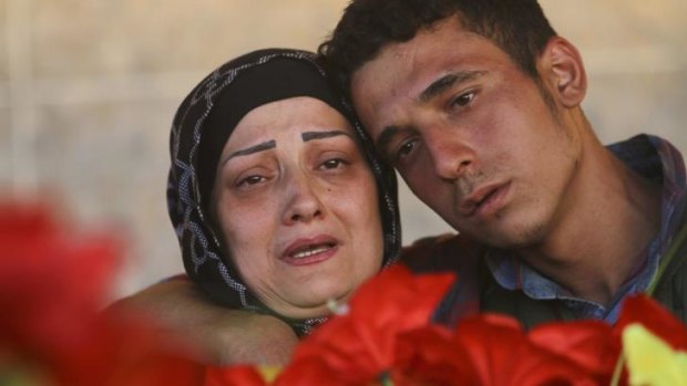 Relatives mourn the death of a Kurdish People's Protection Units (YPG) fighter, who was killed during clashes with Islamic State fighters in the Iraqi city of Rabia on the Iraqi-Syrian border.