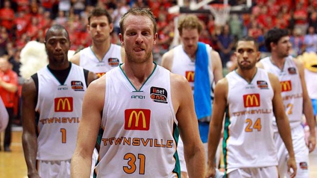 The Townsville Crocodiles leave the court after being defeated by the Perth Wildcats.