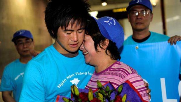 Hong Vo meets son Martin at Melbourne Airport after being detained for protesting in Vietnam.