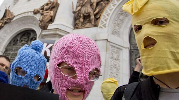 Putin protest: Wearing signature Pussy Riot masks, supporters confront security guards on the steps of the Cathedral of Christ the Saviour .