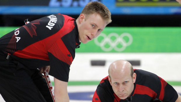 Canada skip Kevin Martin delivers the stone as Marc Kennedy gets set to sweep in a match against Great Britain.