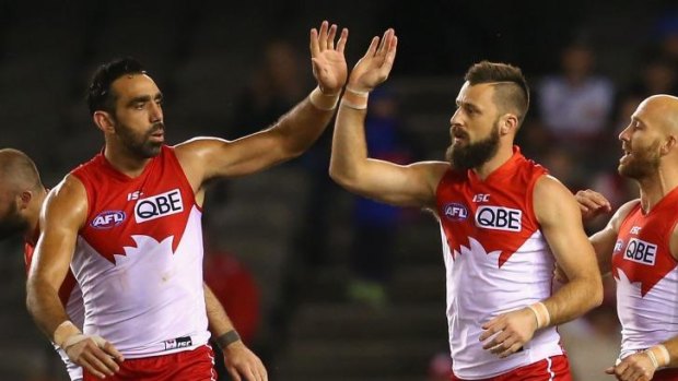 High five: Nick Malceski (right) celebrates a goal with Adam Goodes on Friday night.