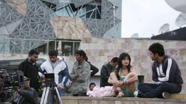 Action...Actress Neha Sharma gets some instructions yesterday as Federation Square become a Bollywood film set.