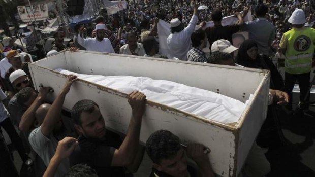 Mourning: Members of the Muslim Brotherhood carry the body of a person killed in recent clashes during a funeral at Rabaa Adawiya Square.