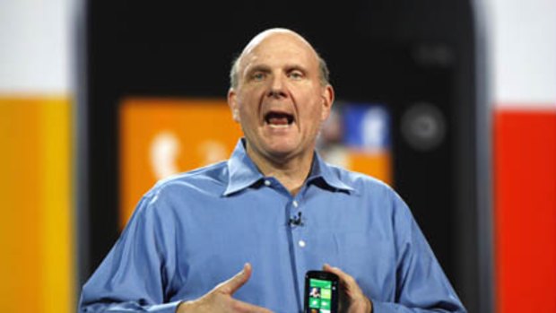 Microsoft CEO Steve Ballmer holds a Windows 7 phone during his keynote address on the eve of the Consumer Electronics Show in Las Vegas.