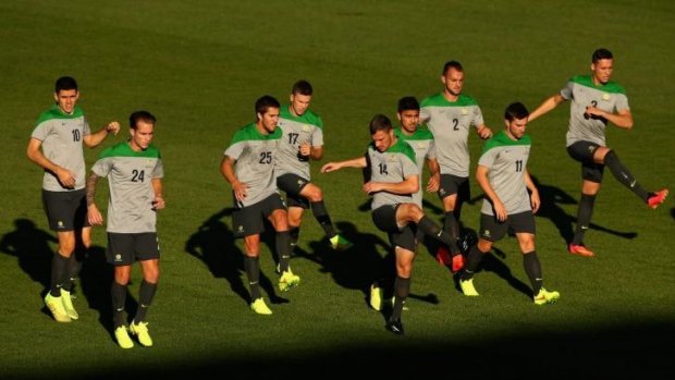 Socceroos players warm up during an Australian training session at Central Coast Stadium.
