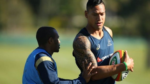 Will Genia  and Israel Folau get together at a Wallabies training session. 