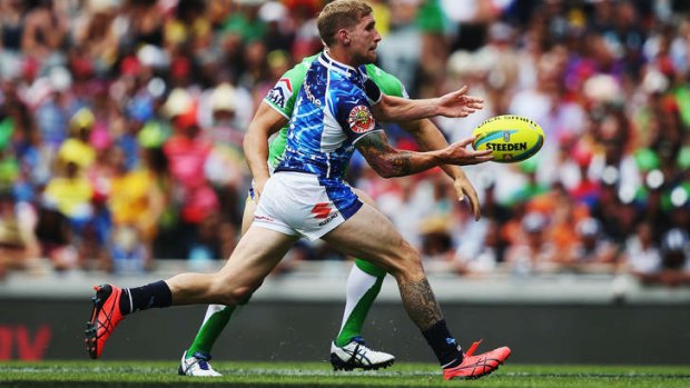 Impact: Star recruit Sam Tomkins passes the ball in the Warriors' win against the Raiders in the Auckland Nines on Saturday.
