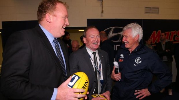 A smiling Mick Malthouse (right) celebrates the win with former Carlton players Lance Whitnall and  Phil Maylin.