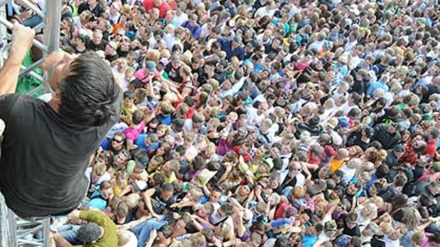 Fans climb out of the crush at the festival after the tragedy.