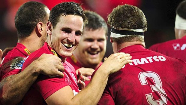Mike Harris and teammates celebrate as the Reds qualify for their second successive Super Rugby finals.