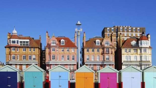 a line of five beach huts on Brighton promenade 5 beach huts are