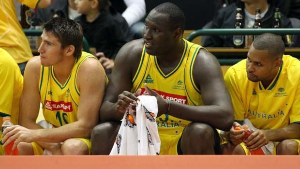 Riding the pine ... Damian Martin, Nathan Jawai and Patrick Mills watch from the bench as Australia record their win over Argentina on Friday night.