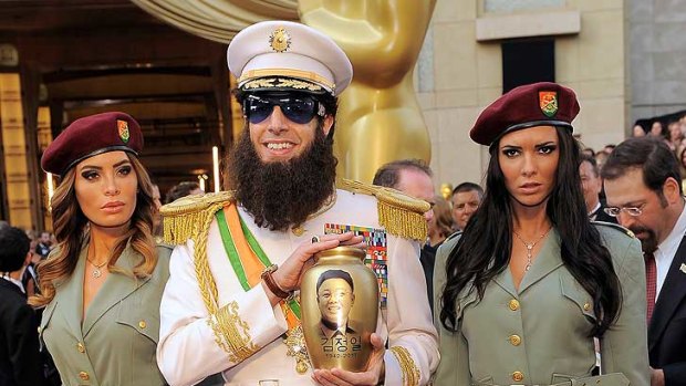 Storming the red carpet ... Sacha Baron Cohen at the Academy Awards with bodyguards and an urn with "Kim Jong Il's ashes".