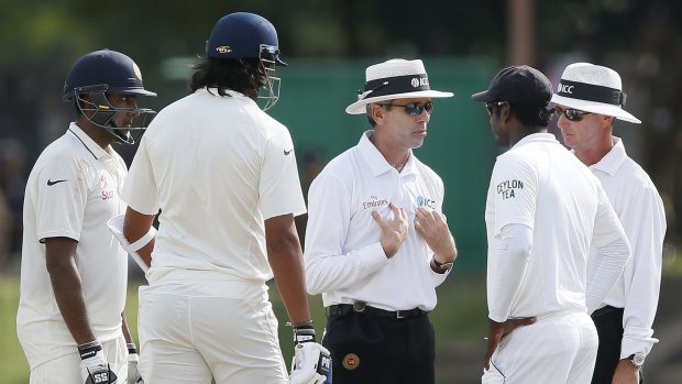 Umpire Nigel Llong (centre) talks to Sri Lanka's captain Angelo Mathews (second right) after an argument between India's Ishant Sharma (second left) and Sri Lanka's Dhammika Prasad (not in picture).