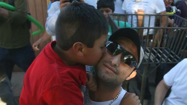 Welcome... rescued miner Carlos Barrios is kissed by a relative as he arrives home in Capiapo, north of Santiago.